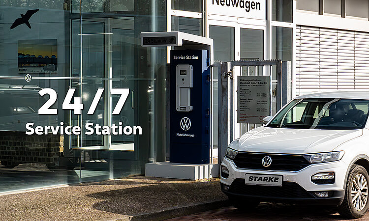 Auf dem Bild ist ein T-Roc neben der Service Station geparkt, an der ein Schlüssel abgegeben und abgeholt werden kann. Auf dem Bild steht link "24/7 Service Station."